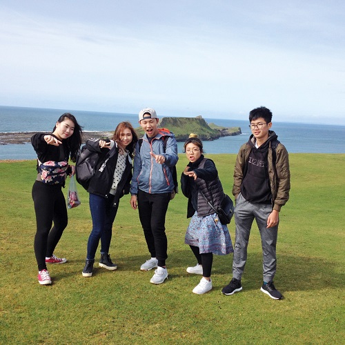gower college asian students by sea